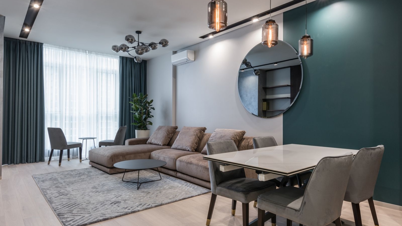 3 BHK interior design in Sarjapur Road 2026, modern living and dining room with teal accent wall by myNivasa