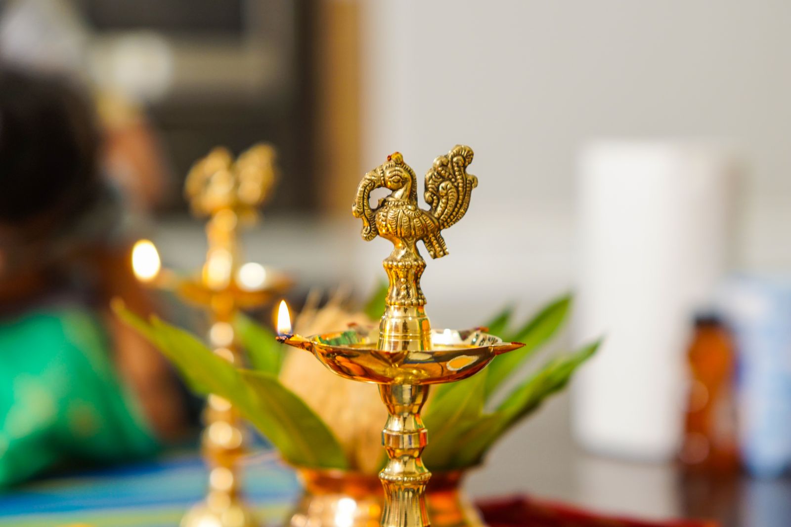 Brass peacock diya lamp for a Bengaluru pooja room design 2026 by myNivasa