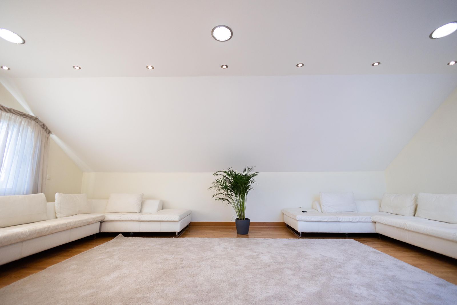 Minimalist false ceiling with recessed spotlights in a Bangalore home living room 2026 by myNivasa