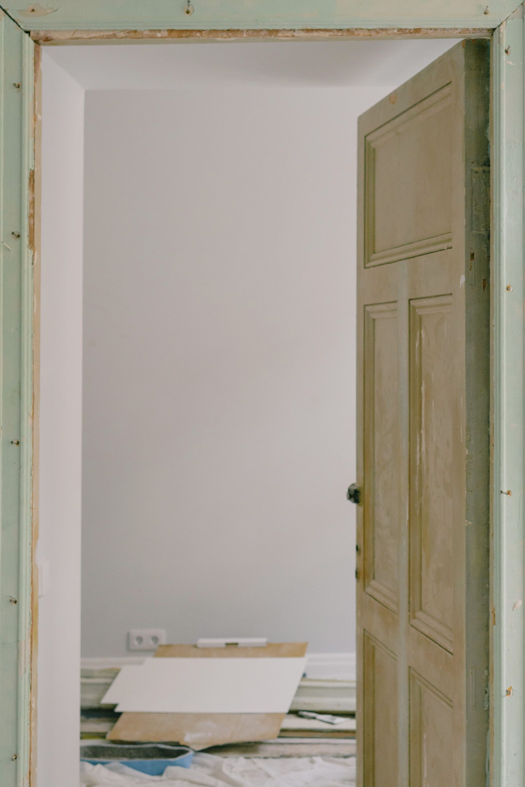 Freshly painted wall and original wooden door during home renovation in Bangalore 2026 by myNivasa