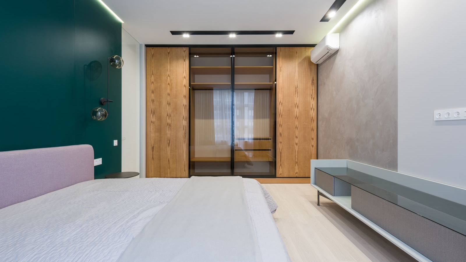 Modern sliding wardrobe with wooden and glass shutters in a Bengaluru bedroom 2026 by myNivasa