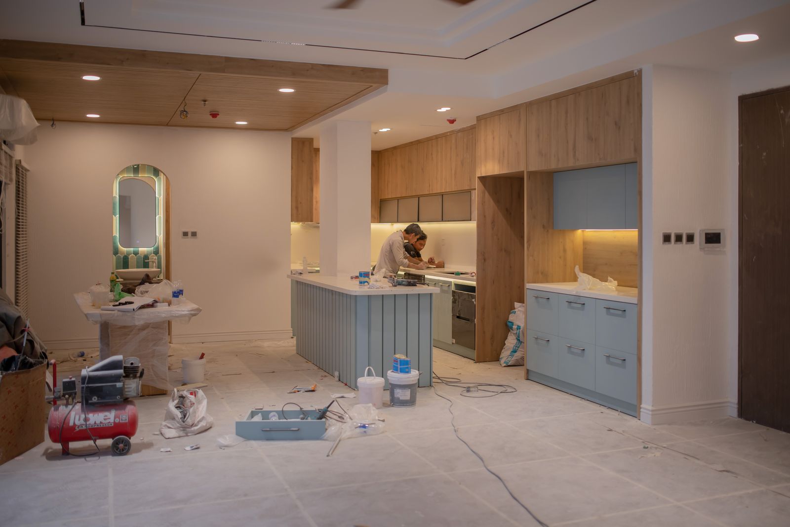 Kitchen interior work in progress with carcasses and shutters being installed, the carcass milestone stage of a Bengaluru interior payment schedule 2026, by myNivasa