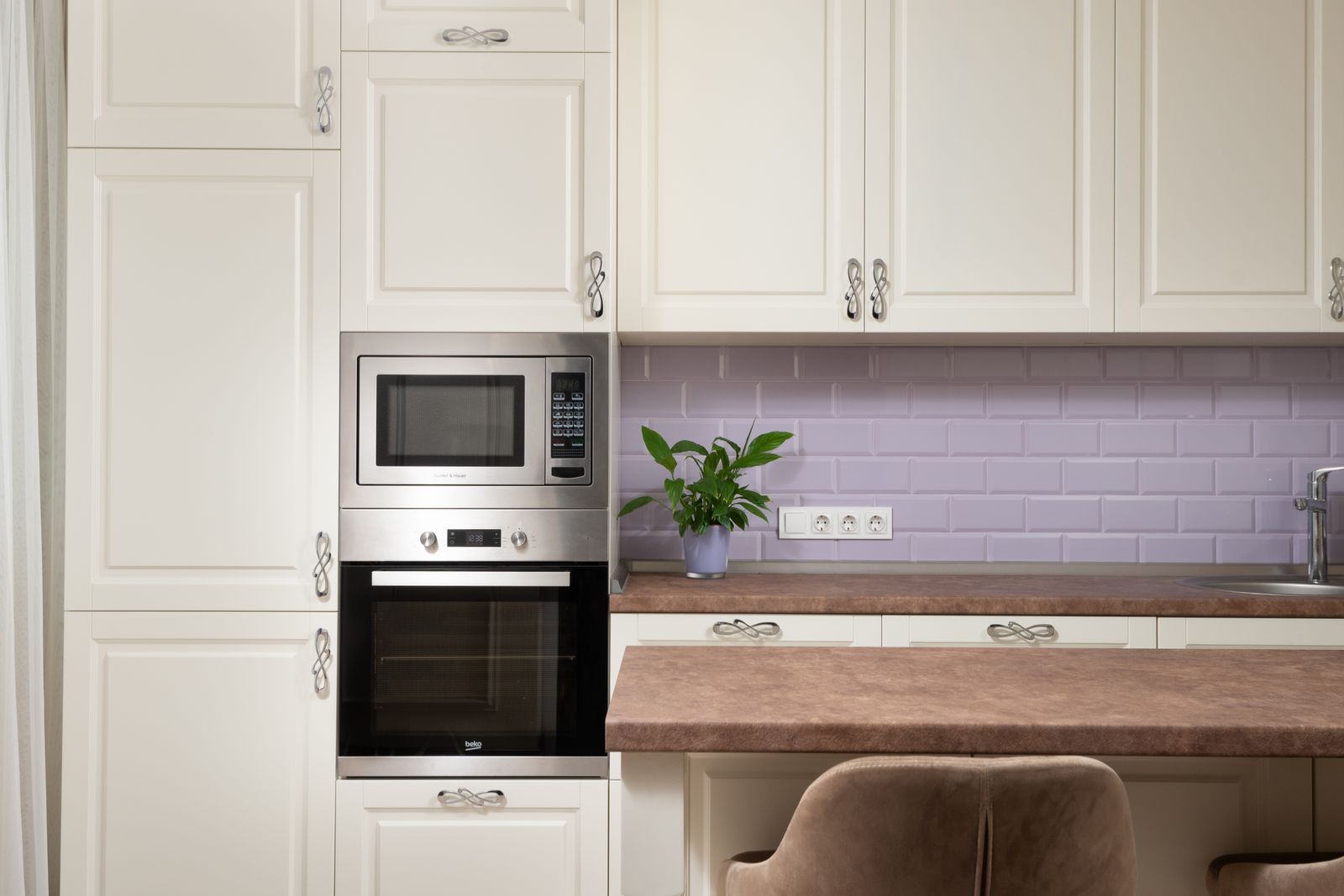 Kitchen backsplash tiling and electrical sockets in a Bengaluru modular kitchen 2026, billed separately from cabinetry, by myNivasa