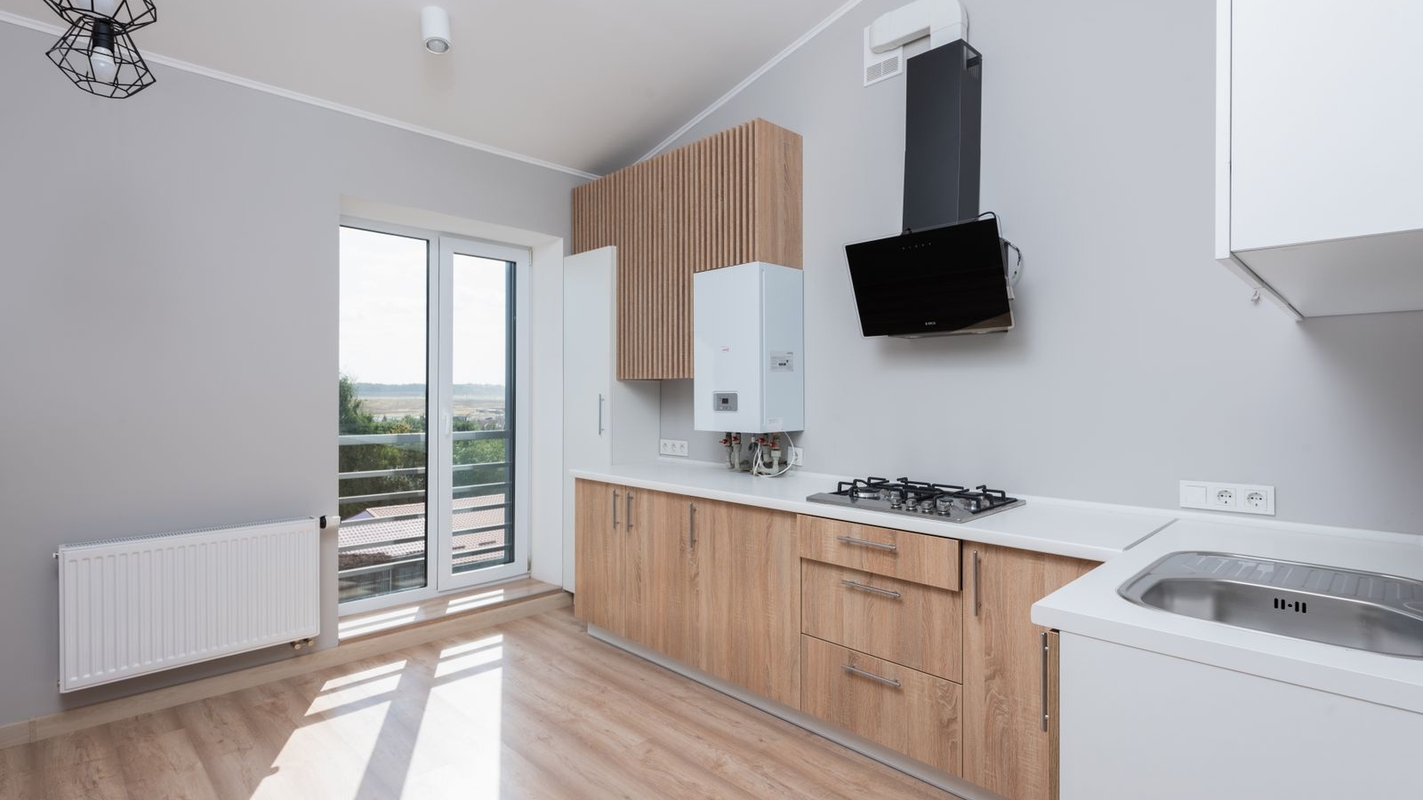 Modular kitchen in Bengaluru 2026 showing chimney, hob, sink and countertop, the items excluded from a cabinetry quote, by myNivasa