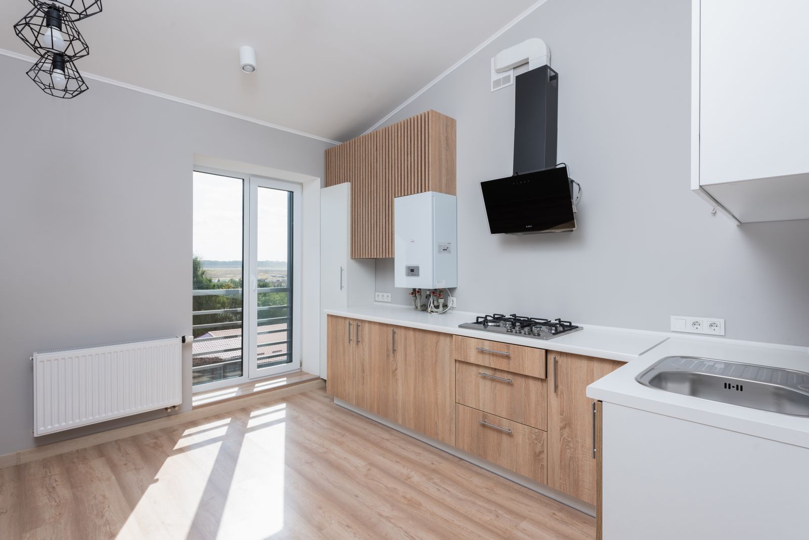 Modular kitchen in Bengaluru 2026 showing chimney, hob, sink and countertop, the items excluded from a cabinetry quote, by myNivasa
