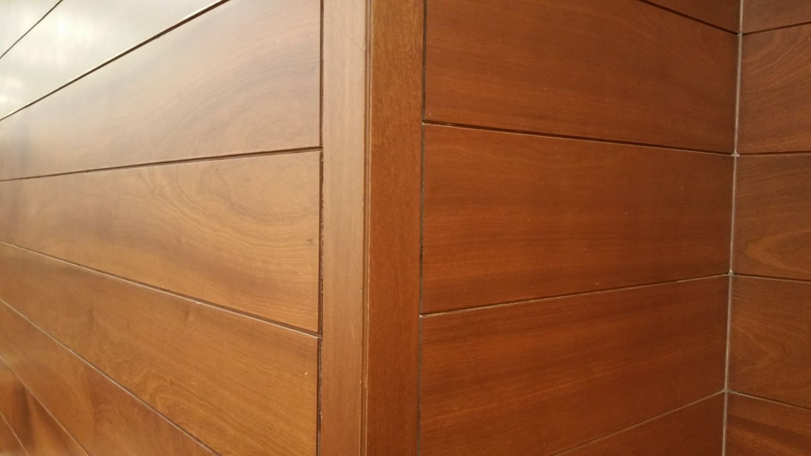 Close-up of a wall panelling corner joint showing the vertical corner profile that covers the cut edge, Bengaluru 2026, by myNivasa