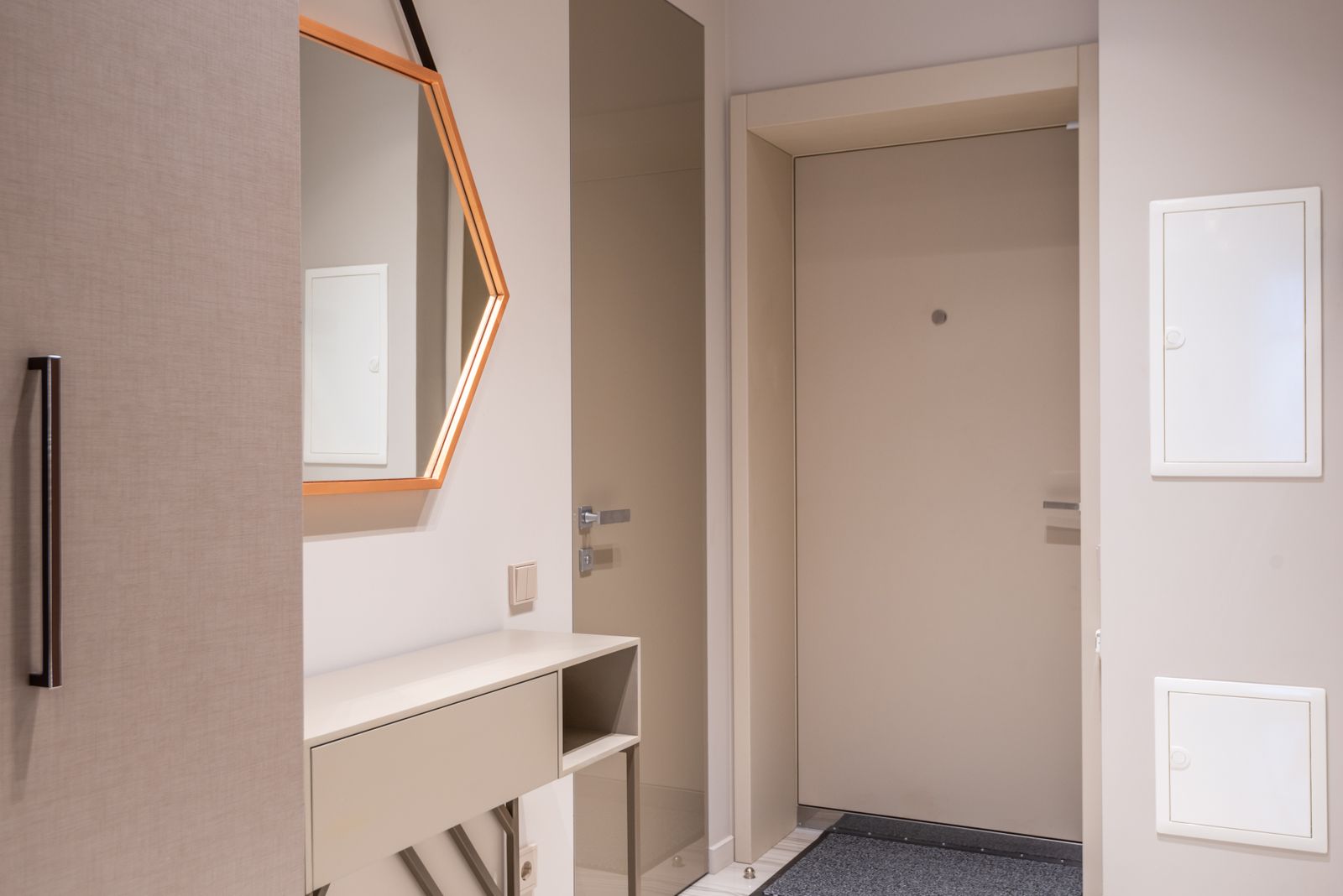 Shallow wall hung entrance unit with a tilt out front fitted beside the main door of a narrow apartment entry, keeping the walkway clear, entrance shoe cabinet cost Bengaluru 2026, by myNivasa