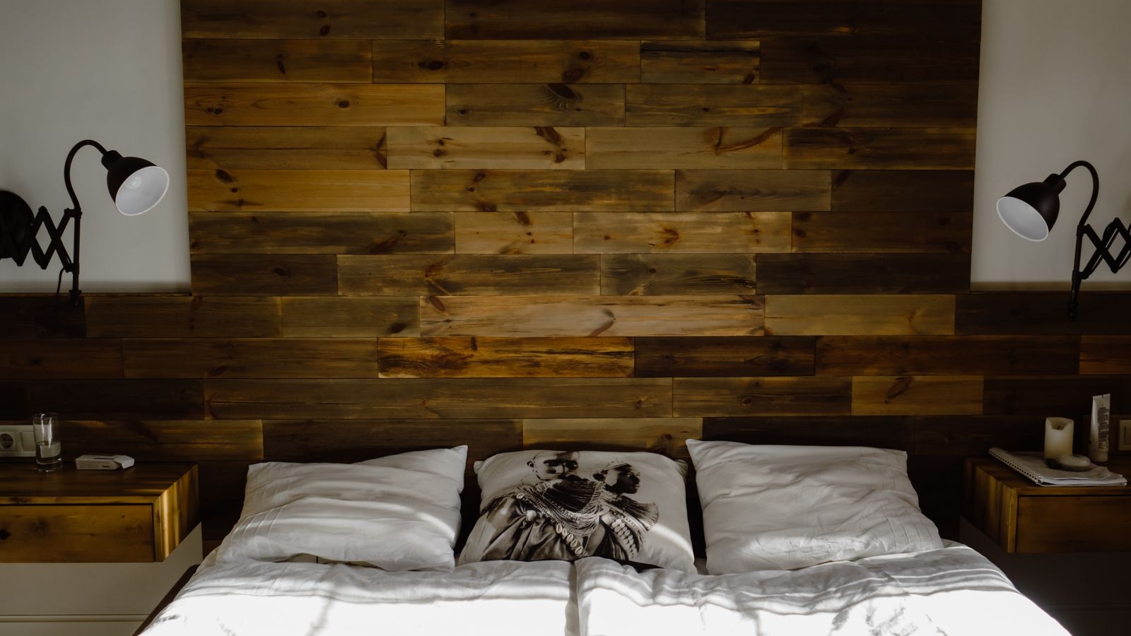 Bedroom with a dark wooden panel headboard wall and white bedding, a Bengaluru bed setup suited to a hydraulic storage frame, 2026, by myNivasa