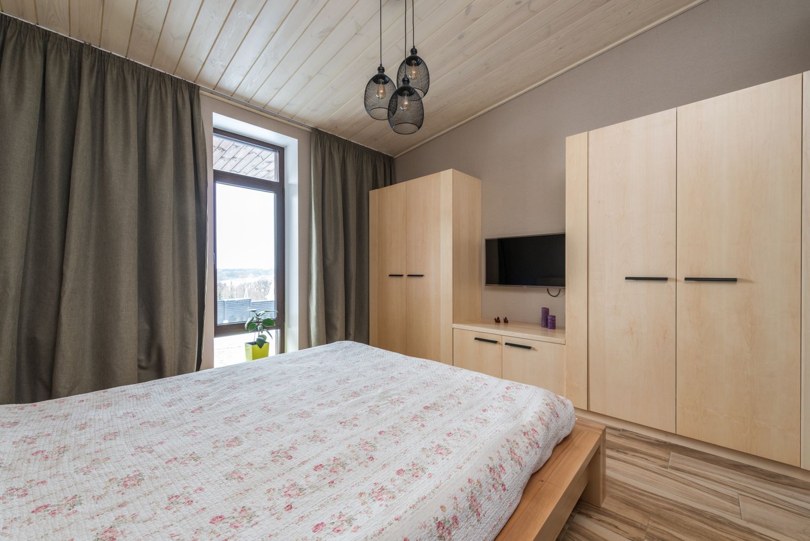 Bedroom with a low wooden platform bed, floor-length curtains and wardrobes, a layout that suits a hydraulic storage bed in a Bengaluru apartment 2026, by myNivasa