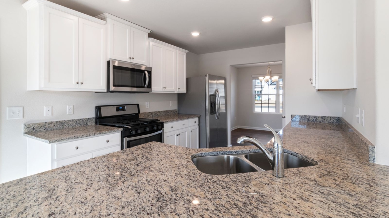 Granite kitchen countertop with existing white cabinets in a Bengaluru apartment kitchen, countertop replacement 2026, by myNivasa