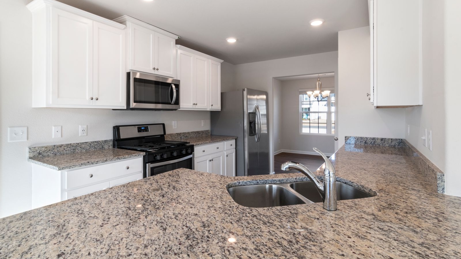 Granite kitchen countertop with existing white cabinets in a Bengaluru apartment kitchen, countertop replacement 2026, by myNivasa