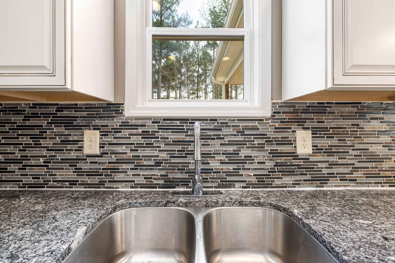 Undermount sink cutout in a speckled granite kitchen countertop with tiled backsplash, Bengaluru countertop replacement 2026, by myNivasa