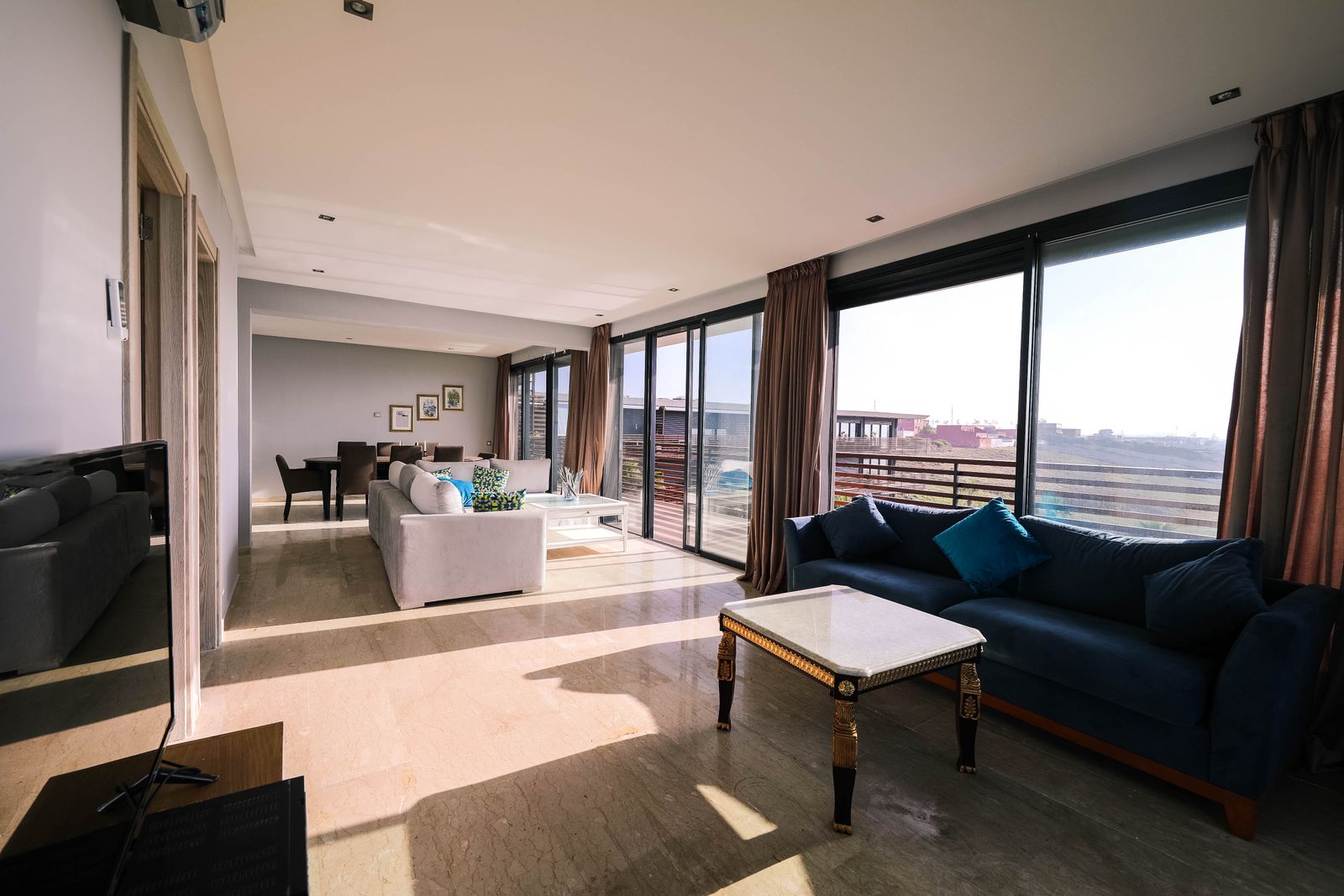 Living room with large sliding glazed windows facing an open view, Bengaluru 2026, by myNivasa