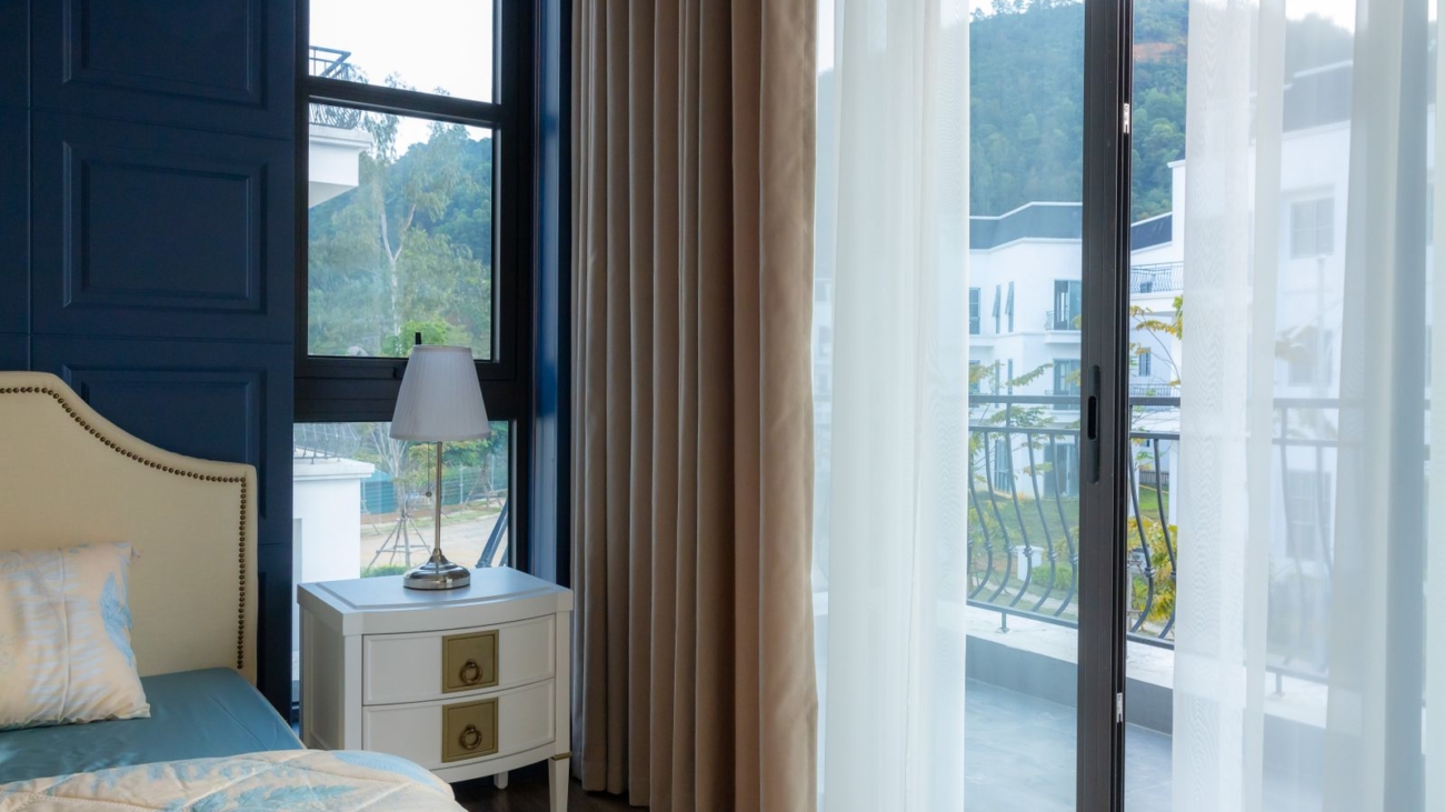 Bedroom window and balcony slider in a Bengaluru apartment before uPVC replacement, 2026, by myNivasa