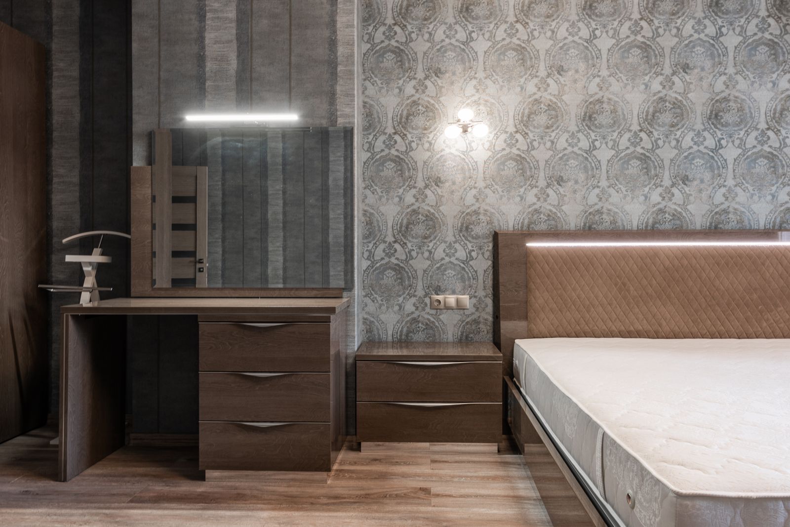 Bedroom with grey patterned wallpaper on the headboard wall and a dressing table, Bengaluru 2026, by myNivasa