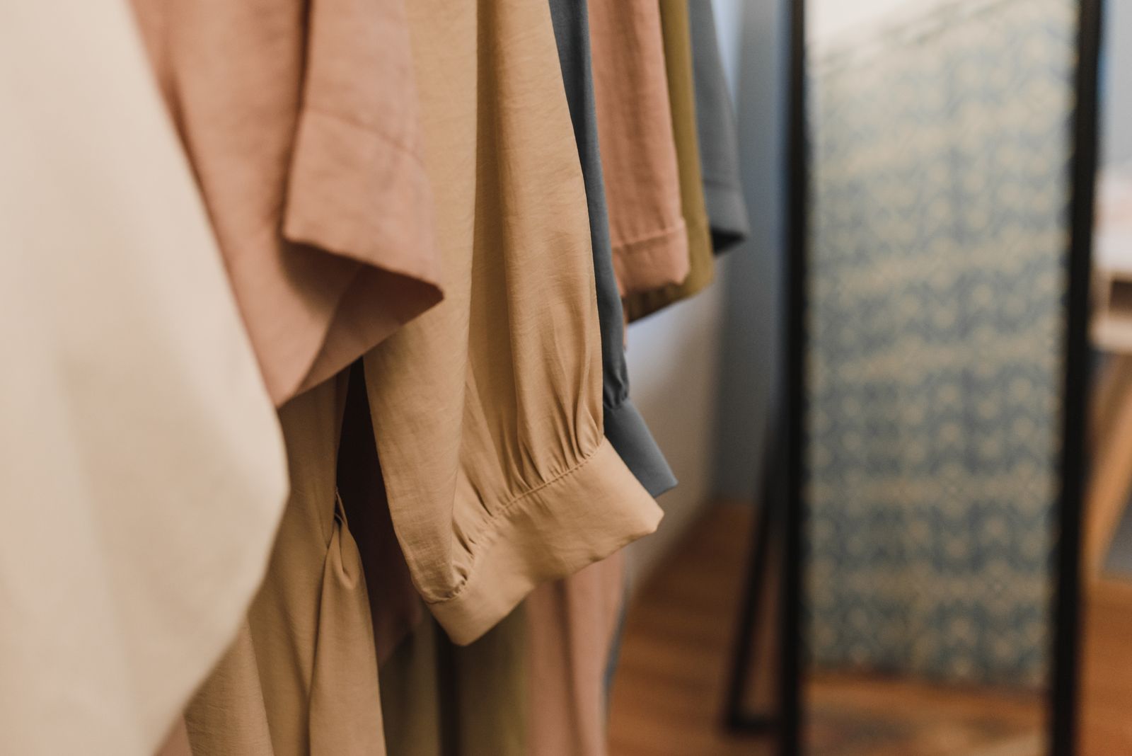 Close-up of garments hanging square on a rod with clearance behind the shoulder, wardrobe hanger depth Bengaluru 2026 by myNivasa