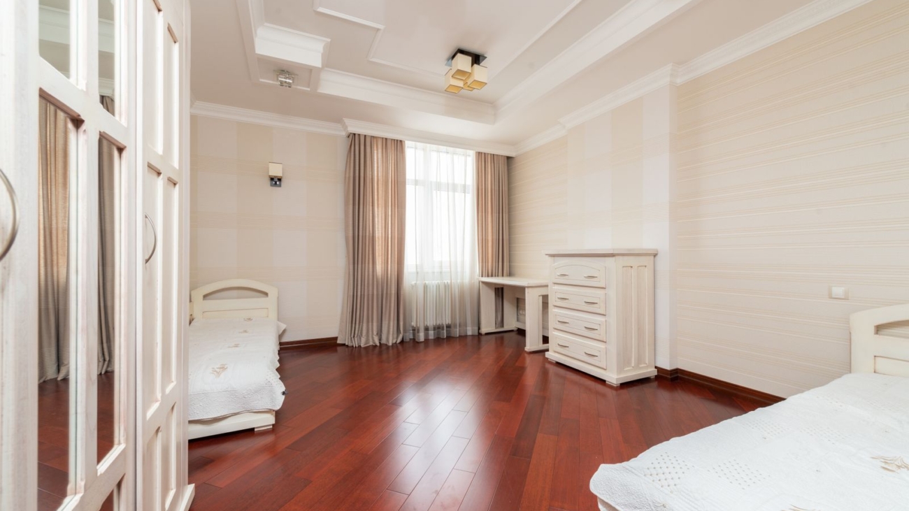 Bengaluru bedroom with dark wooden plank flooring, wardrobe and window, interior design 2026 by myNivasa