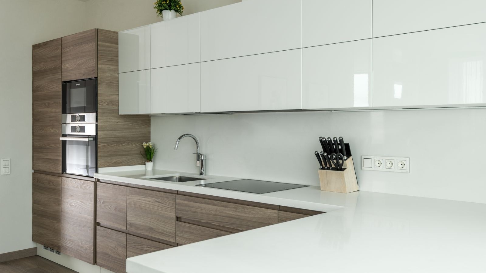 Modern Bengaluru style kitchen with wood grain base cabinets and glossy white wall cabinets showing clean laminate edges, edge banding guide 2026, by myNivasa