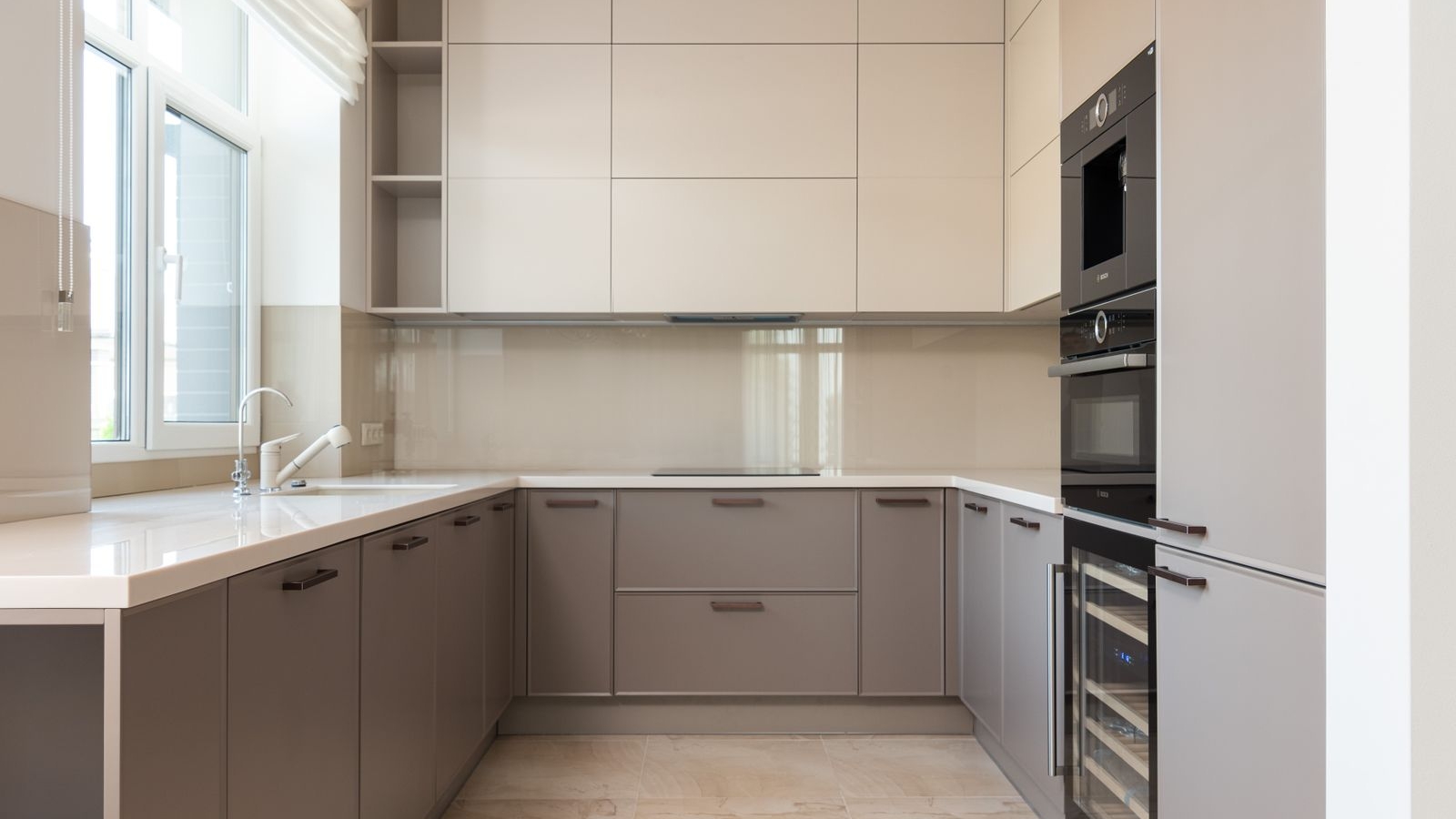 U-shaped modular kitchen with beige and taupe cabinets and a white countertop in a Bengaluru home, layout cost guide 2026, by myNivasa