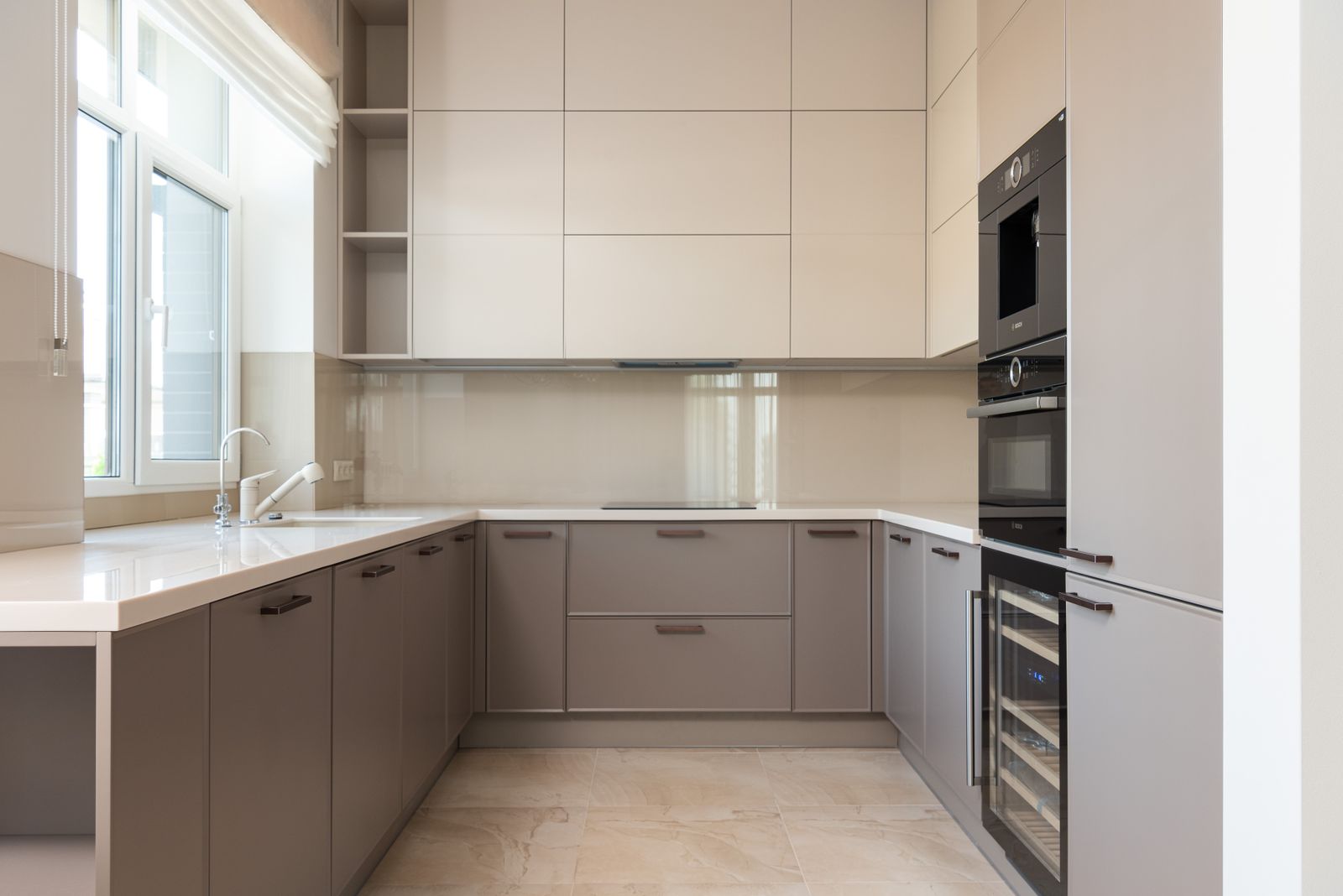 U-shaped modular kitchen with beige and taupe cabinets and a white countertop in a Bengaluru home, layout cost guide 2026, by myNivasa
