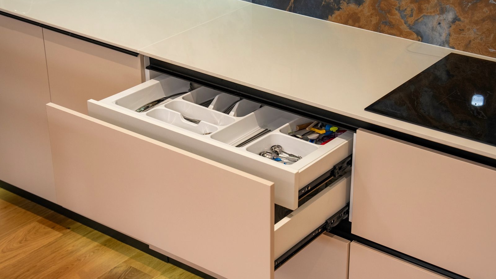 Open kitchen drawer with a side mounted telescopic channel and cutlery tray in a modern Bengaluru kitchen, 2026, by myNivasa