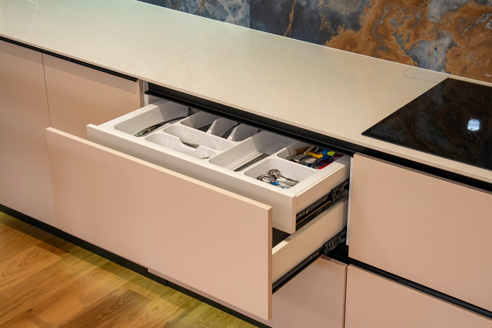 Open kitchen drawer with a side mounted telescopic channel and cutlery tray in a modern Bengaluru kitchen, 2026, by myNivasa