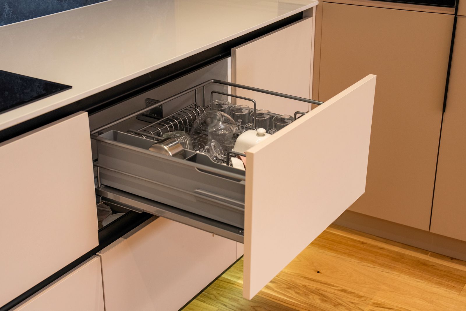 Kitchen drawer with grey steel tandem box sides holding glassware in a modern Bengaluru kitchen, 2026, by myNivasa