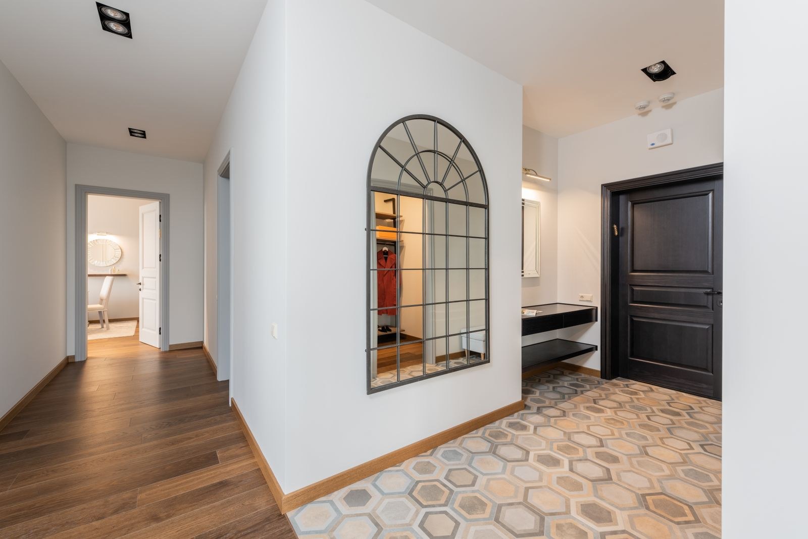Hexagon patterned tile entrance meeting a wooden floor in a Bengaluru apartment passage, 2026, by myNivasa